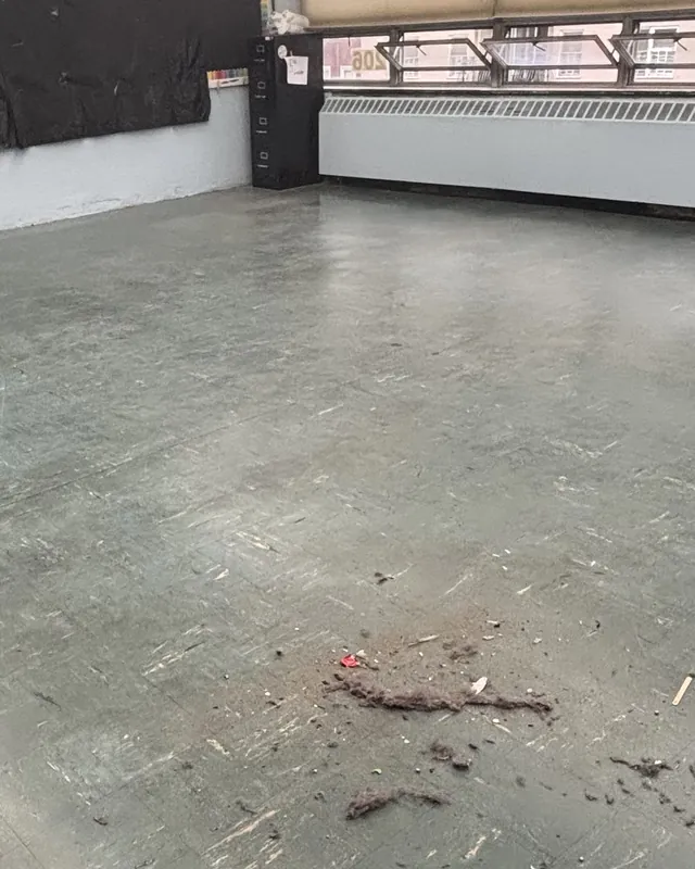 Before: the classroom floor dull and scuffed, with debris in the middle of the room.